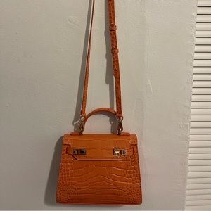 It can be either crossbody bag or hand bag.